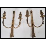 A pair of early 20th Century gilt brass Adams revival wall sconces having ormolu decoration with