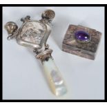 A silver hallmarked lil bo peep babies rattle having mother of pearl teething handle along with a