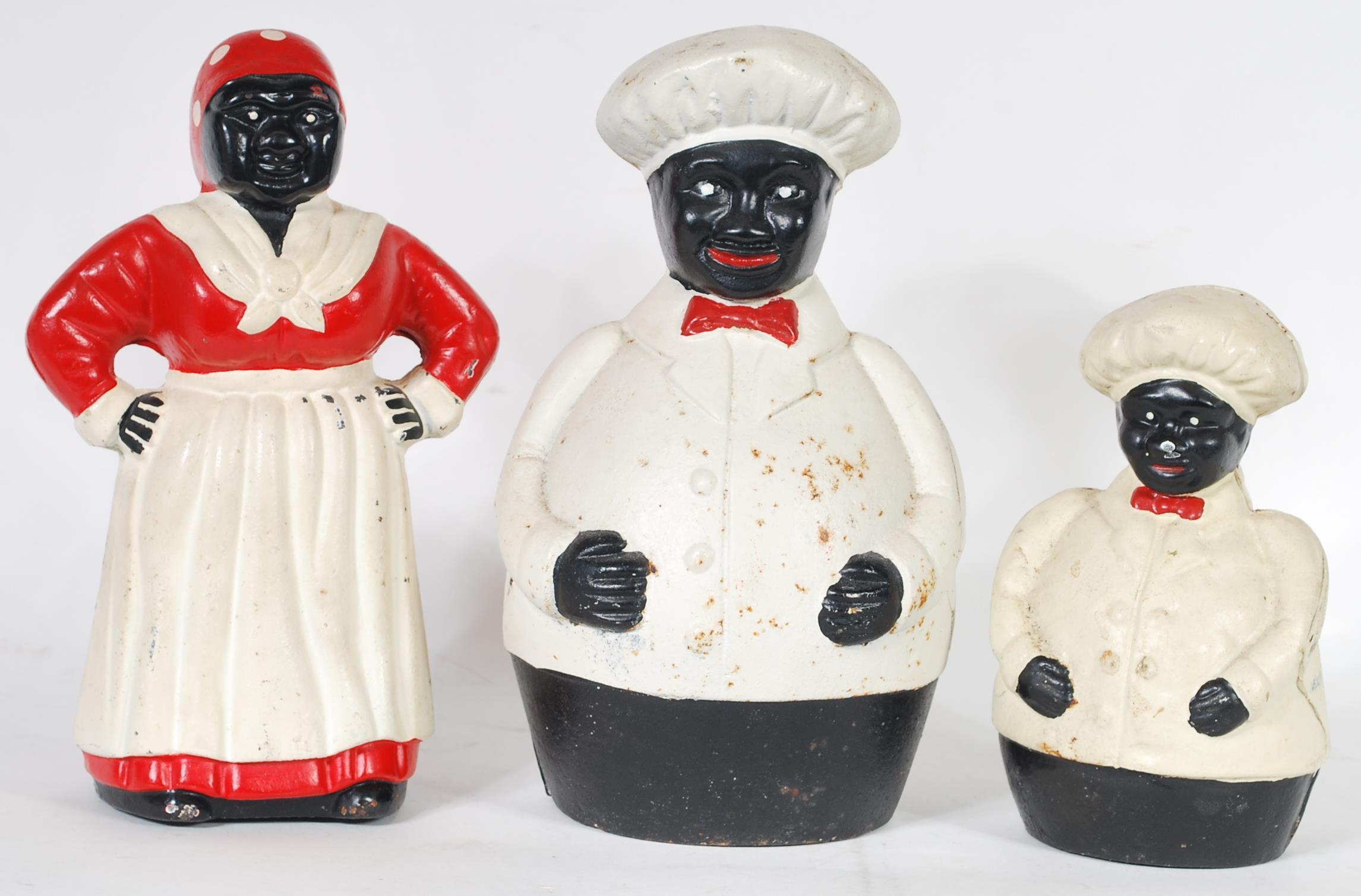 A collection of three cast metal Negro money boxes in the form of jolly fat chef's and a cook. All