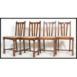 A set of four early 20th Century circa 1930's rail back dining chairs raised on barley twist
