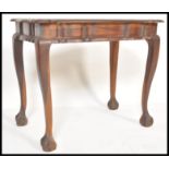 An early 20th Century South African Cape stinkwood writing table raised on ball and claw feet in the