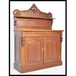 A Victorian 19th century style mahogany chiffonier sideboard. Raised on a plinth base with twin door