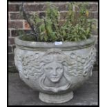 A vintage 20th century antique style reconstituted garden stone, the planter having human face