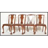 A set of four Edwardian mahogany dining chairs, the chairs being raised on Queen Anne claw and