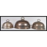 A collection of three 20th Century silver plated graduating meat platters having gadrooned finial