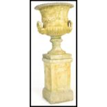 A large  20th Century well weathered stone garden planter campana  urn raised on square column