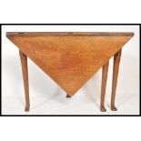 An early 18th Century Queen Anne or early George I walnut folding game or tea table of unusual