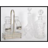 A group of 20th Century English glass decanters to include a decanter set tantalus in silver