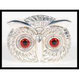 A silver plated vesta case or match holder in the form of an owls head having red glass eyes and