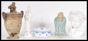 A collection of 20th Century ceramics to include a lidded stoneware urn, raised on pad paw feet