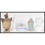 A collection of 20th Century ceramics to include a lidded stoneware urn, raised on pad paw feet