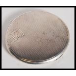 A hallmarked 20th Century silver compact of circular form by William Suckling Ltd having engine