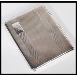 A silver hallmarked cigarette case having an engine turned front and back, Birmingham assay dating