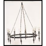 A large 20th Century ebonised iron ceiling light chandelier having eight ebonised sconces with