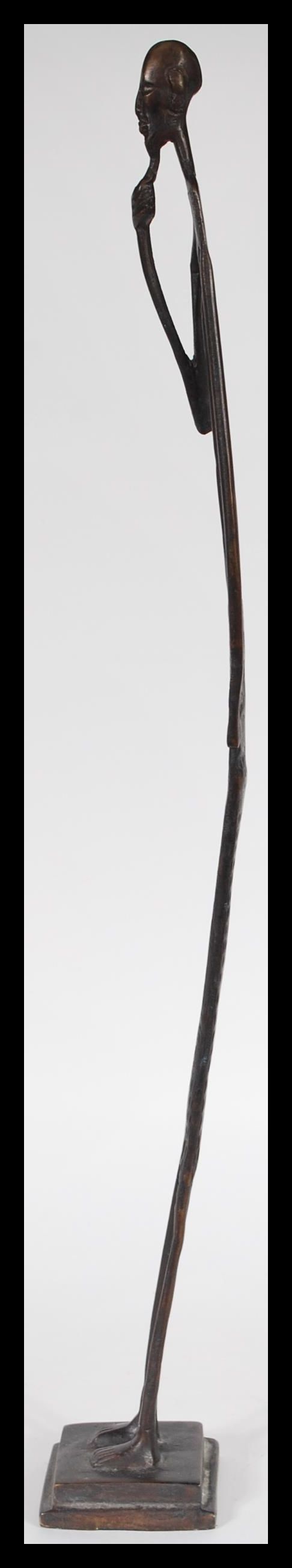 An African tribal bronze figurine of an elongated man stroking his beard raised on square base. 52cm - Image 4 of 5