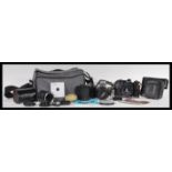 A group of vintage cameras and equipment to include a Zenit 11 camera with a Helios 44M-4 lens,