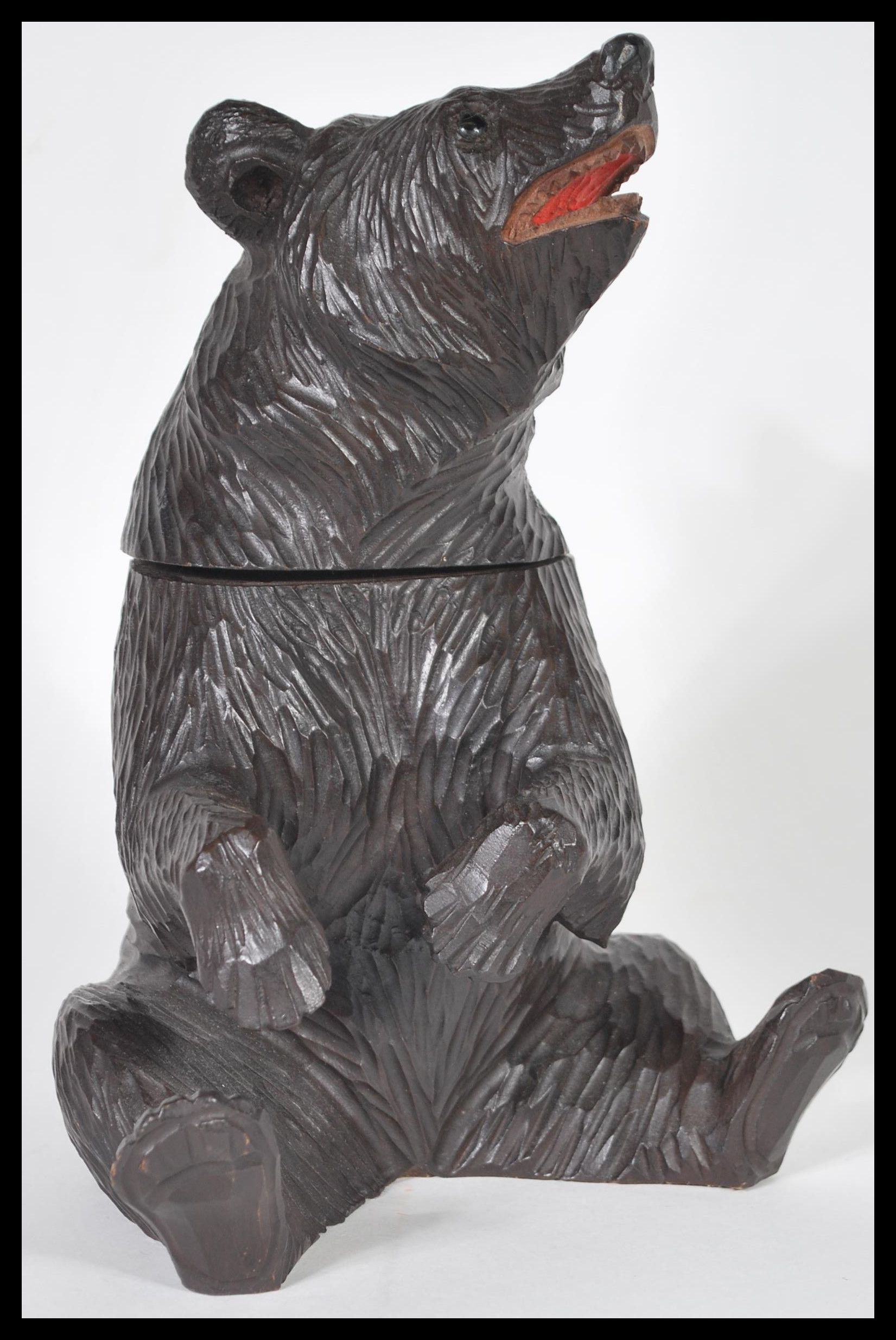 A German Black Forest hand carved wooden tobacco pot or tea caddy in the form of a bear having
