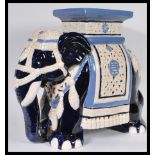 A 20th century large Chinese ceramic planter / stool in the form of an Elephant having painted