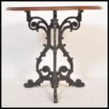 A 20th Century cast metal Victorian style circular pub table with mahogany circular top being raised