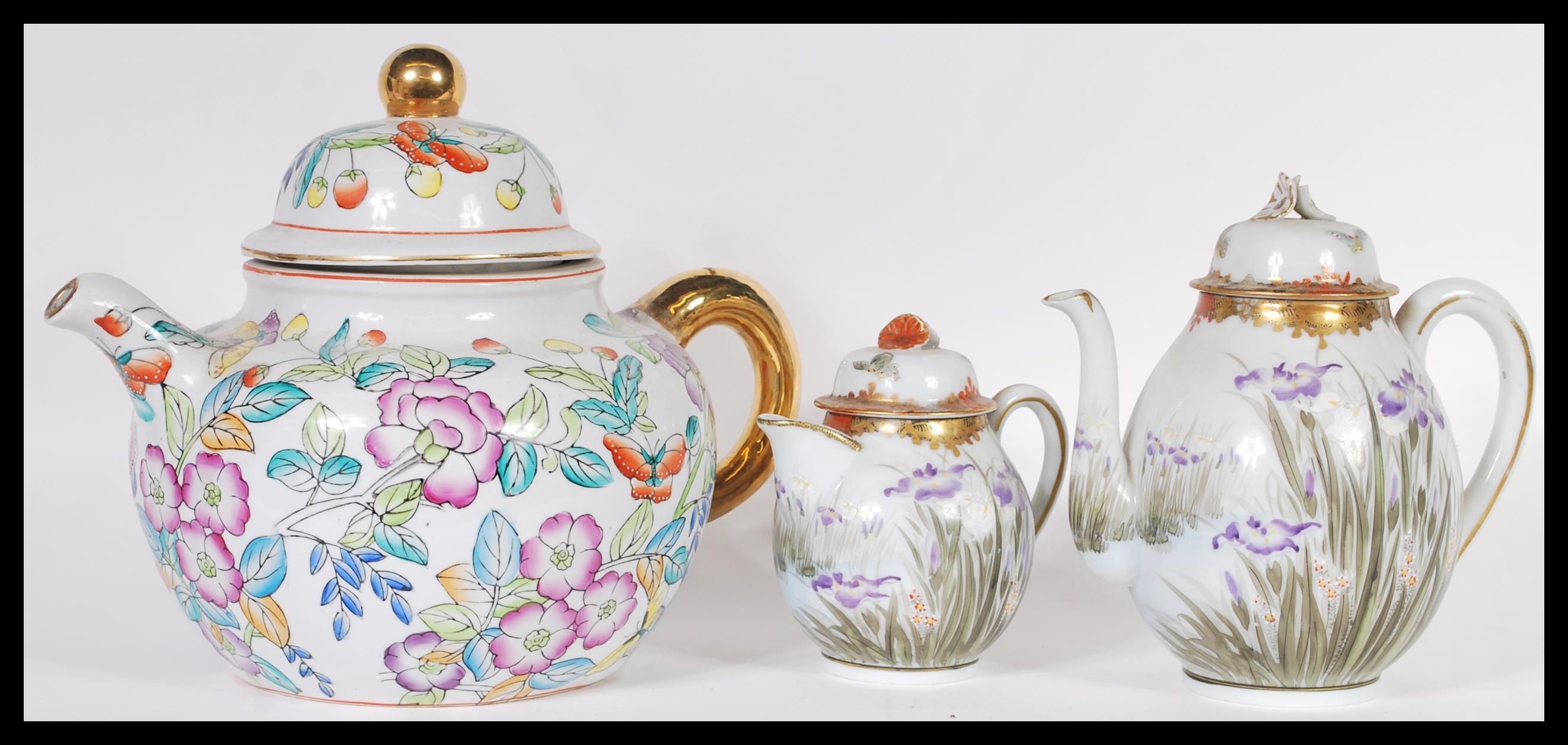 A 20th Century Japanese porcelain coffee pot with hand painted flowers,fauna and butterflies