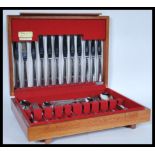 A vintage 20th Century James Ryals stainless steel canteen of cutlery in fitted wooden case. 9cm