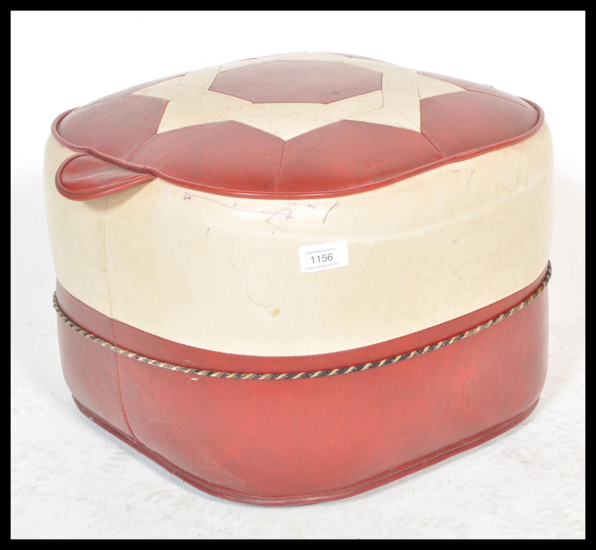 A retro mid century two tone vinyl panel stitched pouffe, having a geometric design to the top.