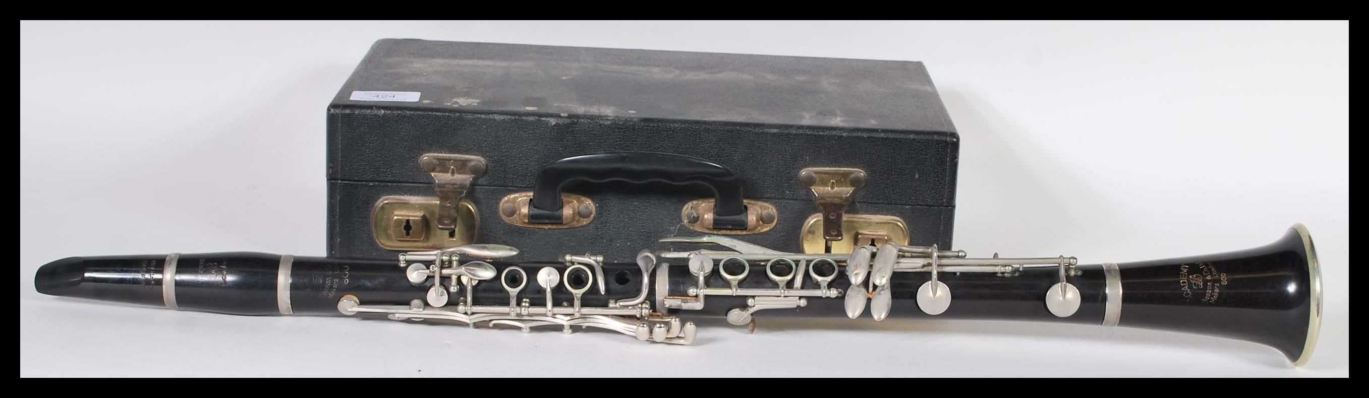 An Academy Besson & Co rosewood clarinet complete in a fitted leather carry case, with a selection