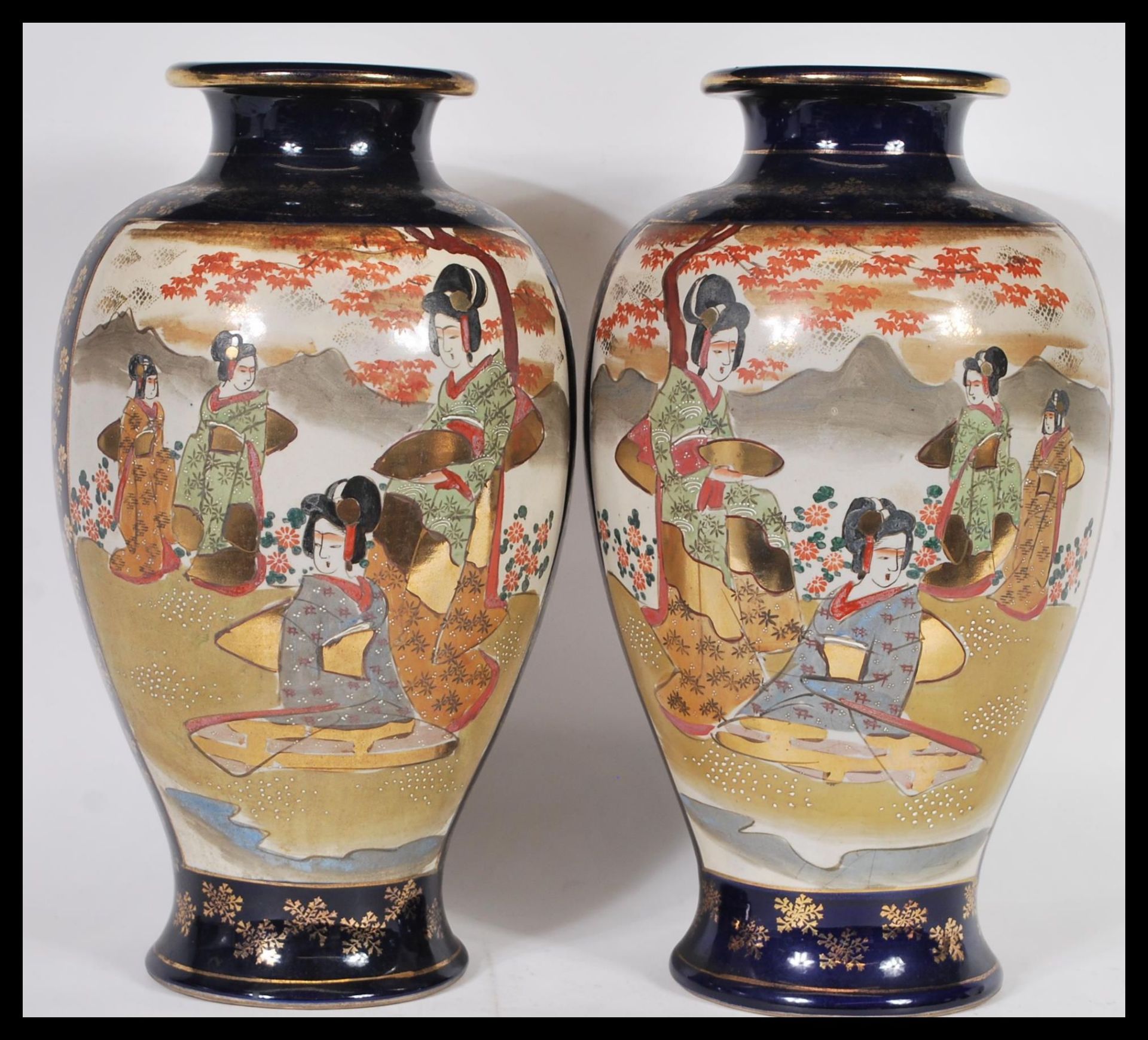 A large pair of Japanese early 20th century baluster vases, each with decorative Geisha scenes and