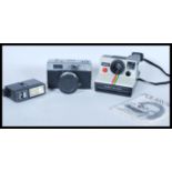 Two vintage film cameras to include a Polaroid Land Camera 1000 and a Halina 3000 film camera with a