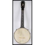 A vintage 20th Century John Grey and Sons four string banjo musical instrument complete in