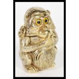 A brass novelty vesta case in the form of a monkey deep in thought.