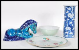 A collection of four pieces of Chinese ceramics to include a blue and white cylinder vase, Tang