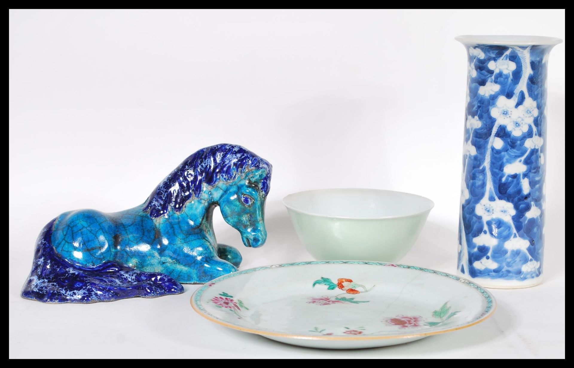 A collection of four pieces of Chinese ceramics to include a blue and white cylinder vase, Tang