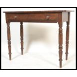 A 19th century Victorian mahogany writing table desk being raised on ring turned uprights. Above a