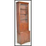 An early 19th Century Georgian tall mahogany cabinet bookcase raised on double cupboard base. The