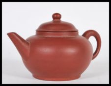A Chinese Kang Yi Xing terracotta / stoneware teapot of simple form having impressed character marks