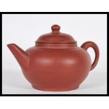 A Chinese Kang Yi Xing terracotta / stoneware teapot of simple form having impressed character marks