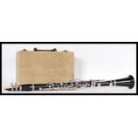 Musical Instruments. A 20th Century ebonised clarinet within a fitted handled carrying case. 69cm