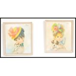 Two vintage 1960's /70's retro Strev prints of little girls holding puppies within white frames.