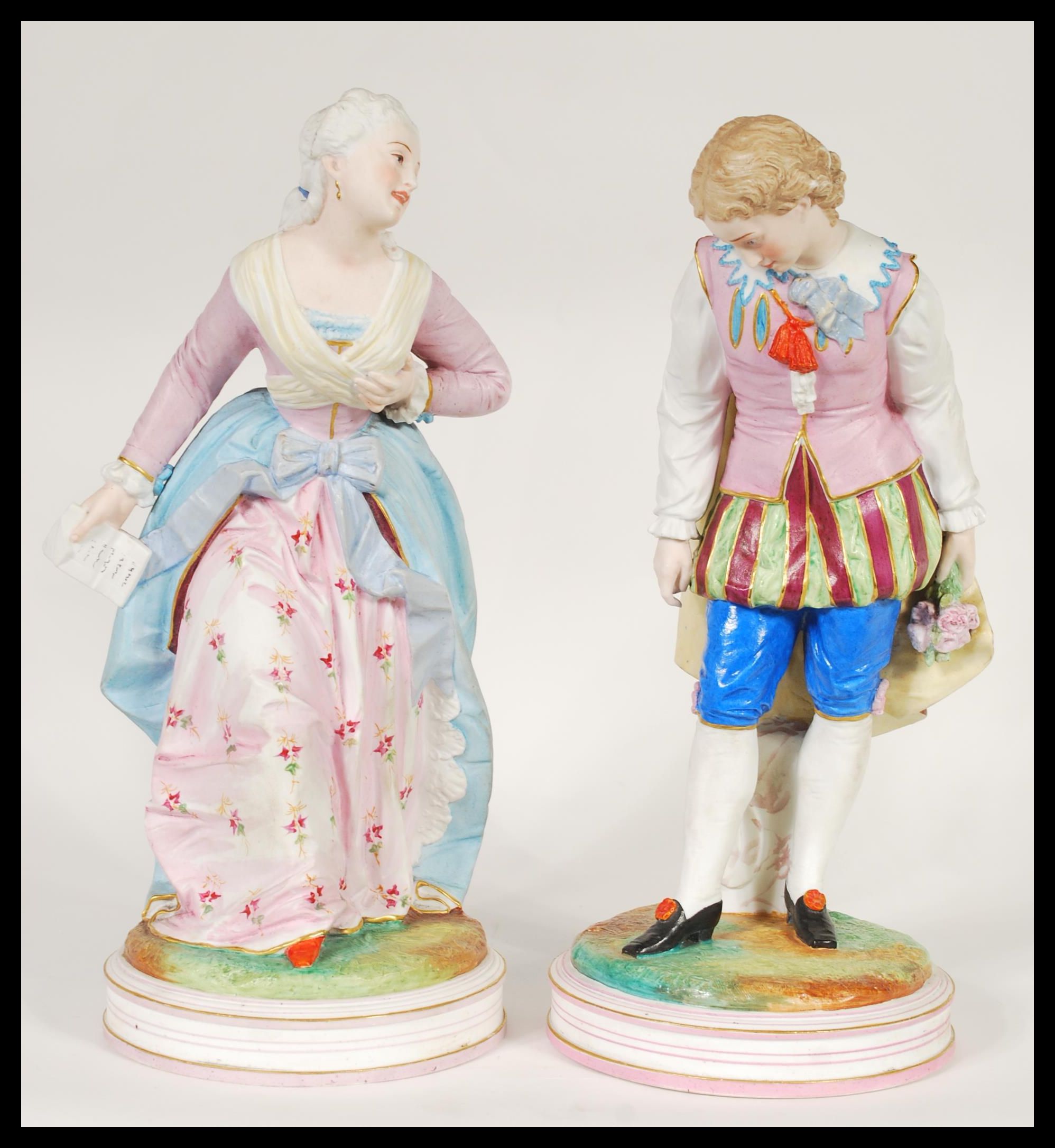 A pair of early 20th Century French Continental Bisque ware figurines depicting a courting couple.