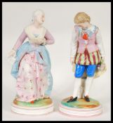 A pair of early 20th Century French Continental Bisque ware figurines depicting a courting couple.