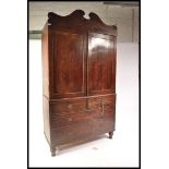 A 19th Century Regency mahogany linen press raised on a two over two chest base with twin cupboard