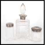 A early 20th century silver topped, cut glass perfume bottle with a glass stopper, makers mark