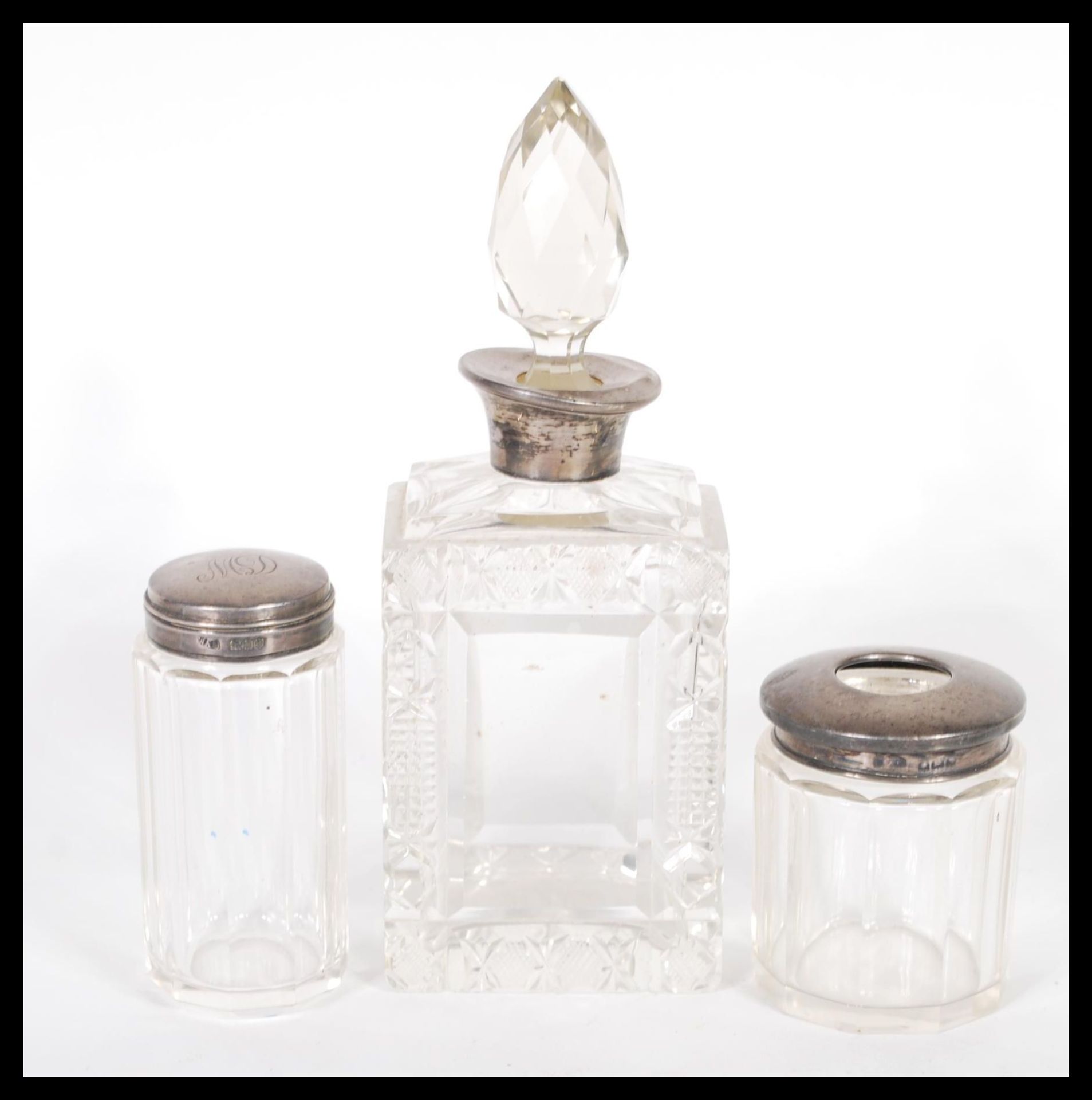 A early 20th century silver topped, cut glass perfume bottle with a glass stopper, makers mark