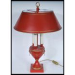 A Louis XVI Bouillotte three light candelabra coaching lamp on a round base with a terracotta