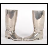 A pair of 20th Century silver plated drinks measures in the form of riding boots having raised