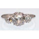 A three stone diamond ring. The ring set with a ce