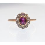 AN 18CT GOLD RUBY AND DIAMOND LADIED CLUSTER RING