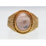 A modern 18ct gold and rose quartz cabochon ring
