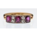 An 18ct gold ruby and diamond ring. The ring being